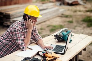Artisan contractor working on a residential job site with tools and safety gear