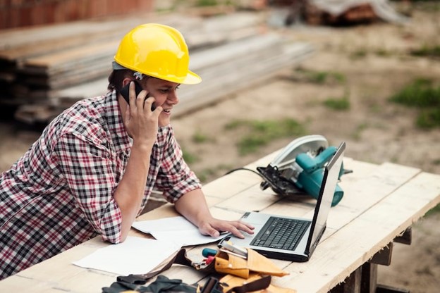 Artisan contractor working on a residential job site with tools and safety gear